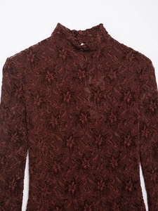 Close-up of the delicate floral lace texture and button back closure on burgundy dress