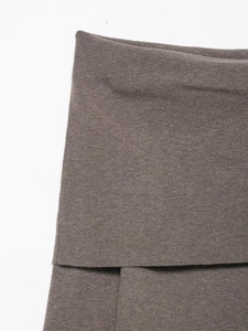 Macro detail of brown fine knit fabric showing the tight ribbed edge and soft texture