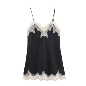 Close-up of black satin camisole with white eyelash lace trim and thin straps