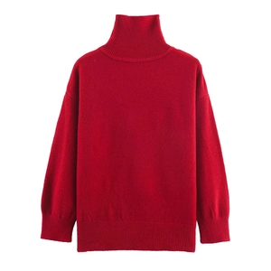 Close-up of the thick ribbed knit texture on a red turtleneck sweater neckline
