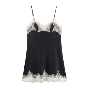 Detail of black satin top with delicate white eyelash lace trim on the hem and neckline
