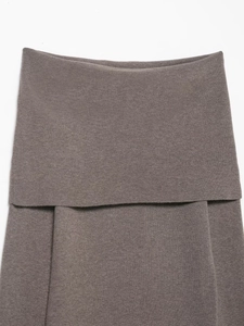 Close-up of taupe knit top texture and wide off-shoulder fold design on white background