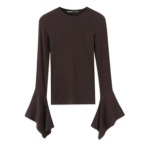 Detail of the crew neck collar and brand tag on a dark brown ribbed knit top