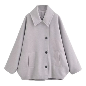 Détails d'une veste en laine gris clair avec revers, boutons à boutonnage simple et poches