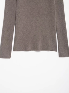 Close-up of taupe off-shoulder knitted sweater showing fine texture and hemline details