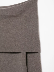 Detailed macro view of brown knit fabric texture and soft pleated seam construction