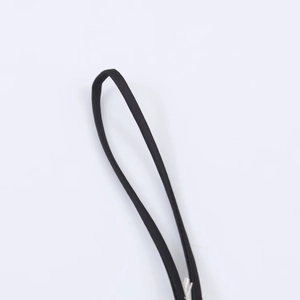 Macro view of adjustable black satin straps with fine texture and white stitching details