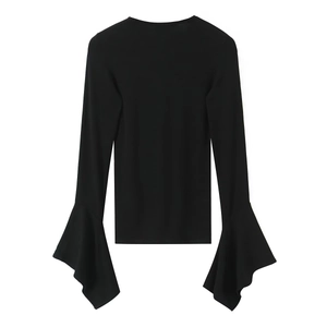 Detail shot of black long sleeve top with layered flared cuffs and rib knit texture