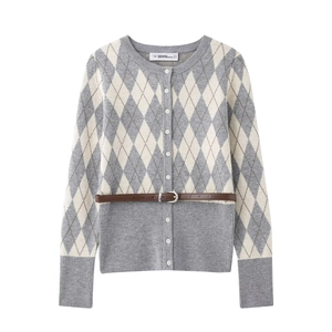 Detail of argyle knit cardigan with round neck, tonal buttons, and thin brown leather belt