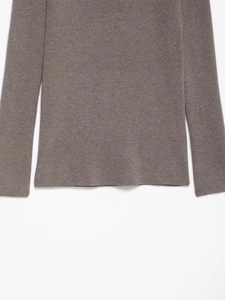 Detailed view of the brown-grey ribbed knit fabric texture and sleeve cuffs on the top