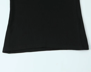 Detailed close-up of black ribbed knit fabric and neat double-needle hem on a long sleeve tee