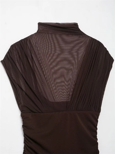 Detail of chocolate brown bodycon dress featuring sheer mesh inserts and ruched fabric