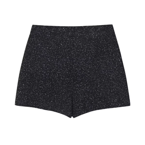 Detailed view of high-waisted black and white tweed shorts with premium textured fabric