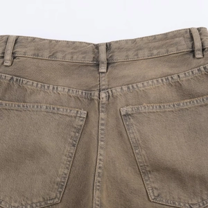 Detail of rear pockets and stitching on vintage tan relaxed fit denim jeans