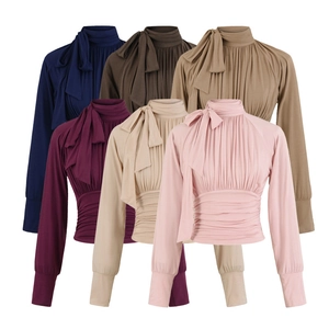 Flat lay of elegant long-sleeve shirts with bow ties in six diverse colors on white background