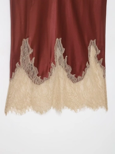 Close-up of smooth satin fabric with exquisite champagne eyelash lace trim detail