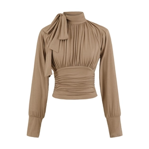 Detail view of khaki long sleeve top featuring bow neck tie and pleated chest texture