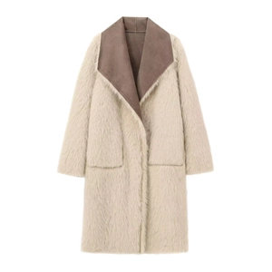 Detail of the contrasting brown lapel and cream faux fur texture on a long winter coat
