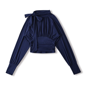 Detailed view of navy blue long sleeve top with elegant bow tie and pleated waist design