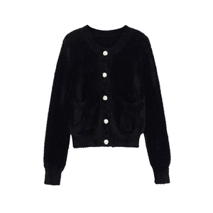 Detailed view of women's black faux mink cardigan with ornate silver wavy buttons