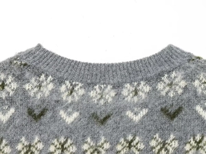 Macro view of tight knit collar with white snowflake jacquard and soft wool texture