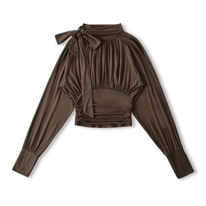 Detail view of coffee brown long sleeve blouse with bow neckline and pleated chest design