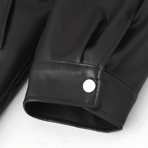 Detail of black double-breasted leather jacket cuff with silver metal snap button and stitching