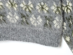 Close-up of winter jacquard knit sweater featuring brushed mohair texture and floral pattern