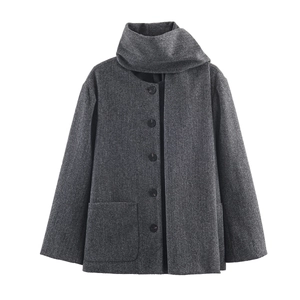 Detail view of grey short wool coat featuring a scarf collar and large front pocket