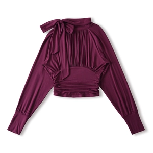 Close-up of pleated dark purple knit top featuring a bow accent and gathered fabric texture