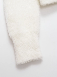 Detailed close-up of soft white fuzzy knit sleeves with ribbed cuffs for women cardigan