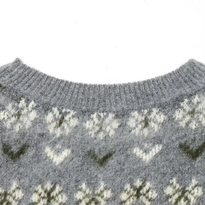 Winter crewneck knit sweater with gray snowflake patterns and soft mohair texture
