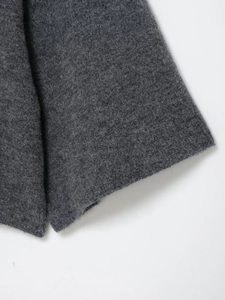 Close-up of deep gray knit fabric texture showing fine weave and high-quality wool material