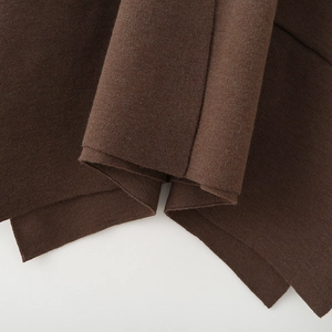 Detailed close-up showing the soft double-sided texture of this brown wool knit poncho