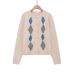 Close-up of knit texture and blue argyle diamond pattern on women sweater