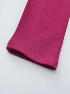 Vue macro d'un poignet en maille côtelée rose rouge avec couture précise à double aiguille