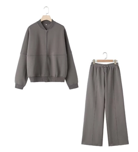 Close-up of a dark grey two-piece tracksuit with zip-up bomber jacket and wide-leg pants