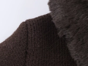 Detail view of deep brown knitted fabric texture with premium faux fur collar trim