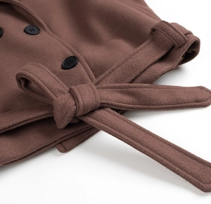 Detail of brown wool coat featuring thick texture, matching waist belt and black buttons