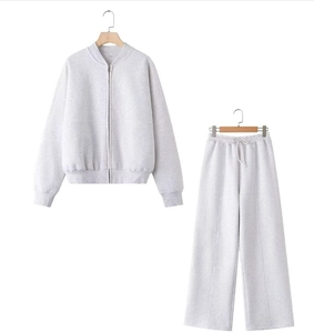 Detail view of light grey cotton knit tracksuit with zipper jacket and wide-leg joggers