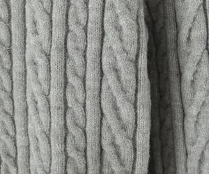 Close-up of the grey cable knit texture and high-quality wool fabric on this stylish set