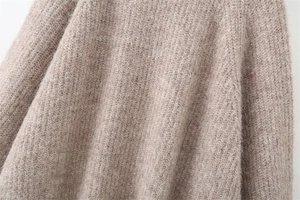 Detailed macro view of the soft brown mohair wool knit texture and fuzzy knit fabric