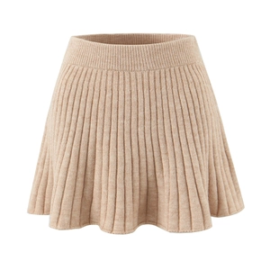 Detail of light beige cable knit mini skirt featuring pleated texture and elastic waist