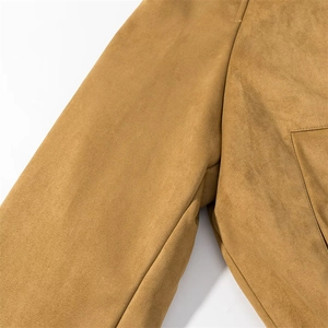 Detail showing high-quality brown suede texture with seamless stitching and side pocket
