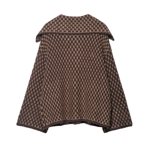 Detailed close-up of geometric knit patterns and wide collar on a brown cardigan