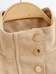 Detailed view of camel suede jacket featuring golden metal buttons and stand collar