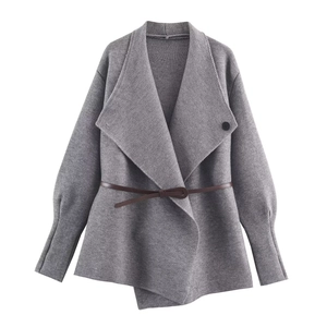 Close-up of gray knit cardigan featuring a wide lapel and a dark brown waist belt
