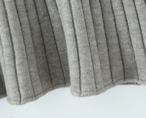 Macro shot of grey rib-knit fabric texture on the soft cardigan and skirt set