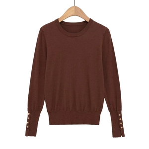 Classic round neck knit sweater in dark brown featuring elegant gold buttons on cuffs
