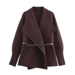 Detail of dark brown woolen jacket with lapel collar and slim leather belt waist